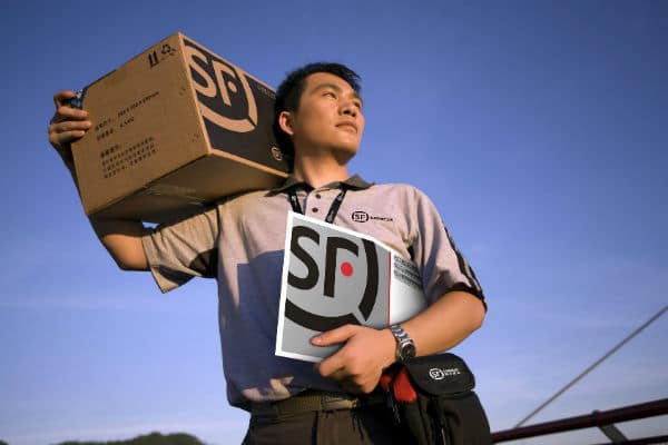Asian male shipping company employee carrying packages