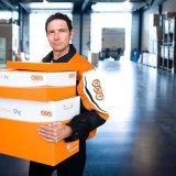 tnt employee holding branded packages
