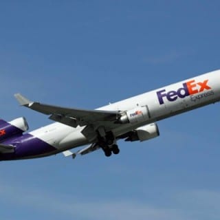 fed ex branded plane in flight