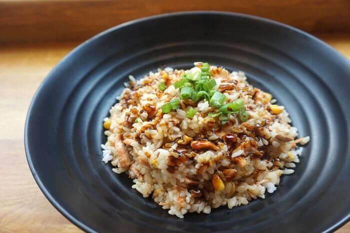 thai food cooked rice in black ceramic plate