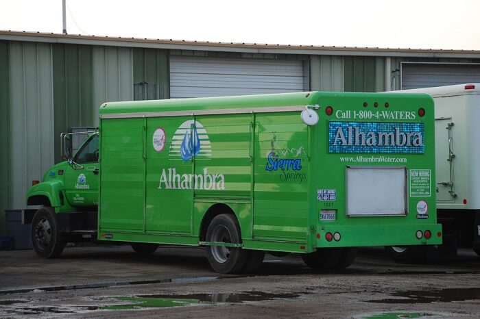 Alhambra delivery truck in front of a home